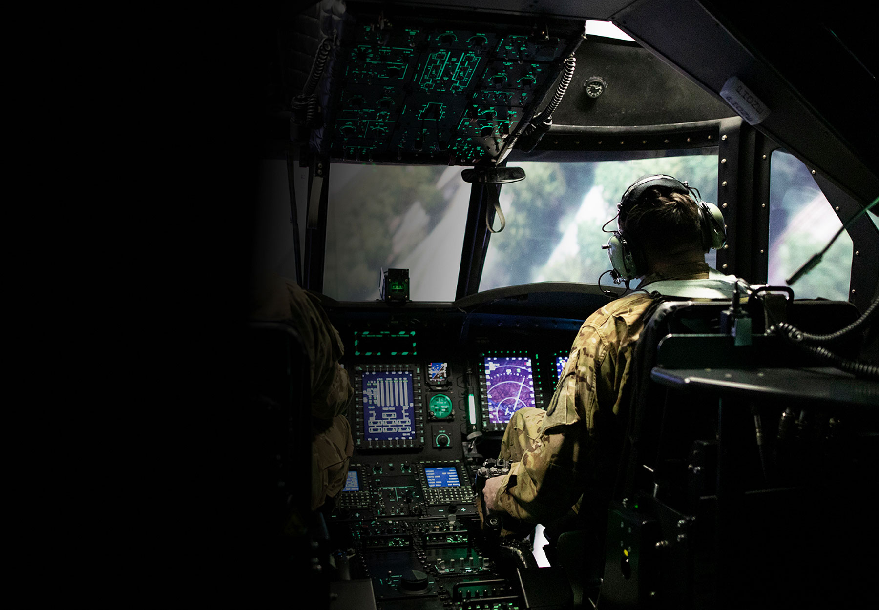 Two Soldiers training inside dark helicopter simulator with glowing switches and buttons 