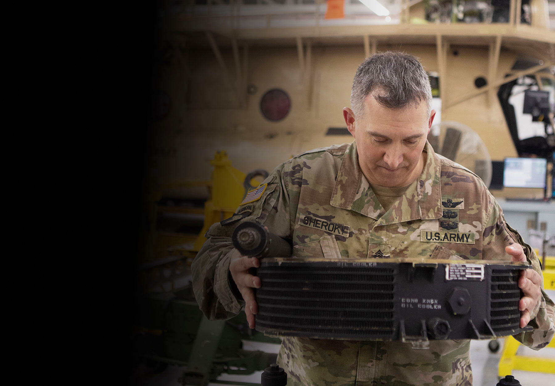 CW2 Snavely casually seated inside a parked Army helicopter